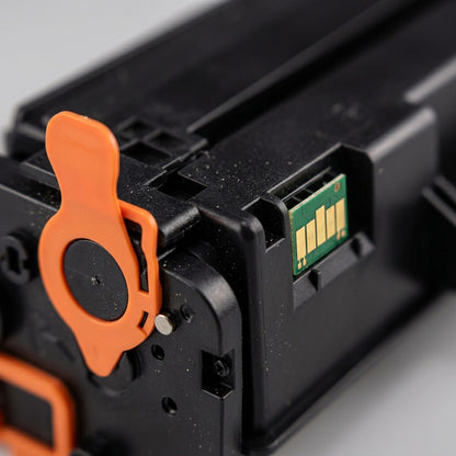 Macro view of the gold contact chip and orange pull tab on an Elevate Imaging HP CF450A toner cartridge.