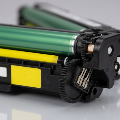 Macro view of Elevate Imaging yellow toner cartridge showing the green OPC drum and gold chip pins.