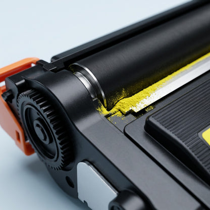 Macro detail of a yellow toner cartridge roller with vibrant yellow powder on the developer edge.