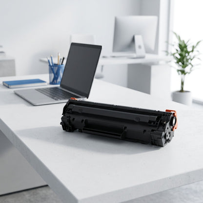 Scale comparison of a black Brother TN760 compatible toner cartridge next to a 13-inch laptop.