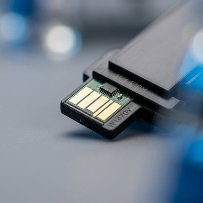 Macro detail of the smart chip with gold contacts on an Elevate Imaging HP W1470Y toner cartridge.
