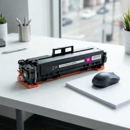 HP 414X laser toner cartridge on a white desk next to a computer mouse and paper for size reference.