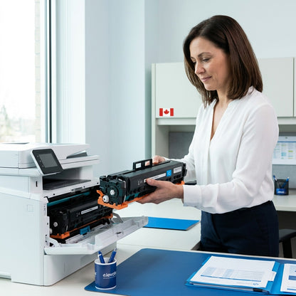 Professional in a bright office installing a cyan HP 206A (W2021A) toner cartridge into a printer.