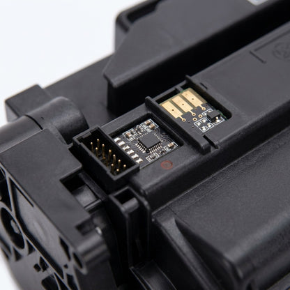 Macro detail of the gold electrical contacts and circuit chip on a Cyan HP 206X toner cartridge.