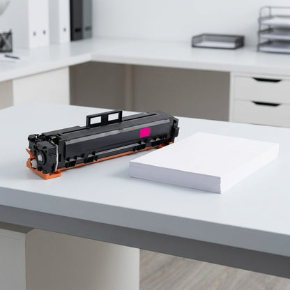 Elevate Imaging magenta laser toner cartridge for HP W2023A beside a stack of A4 paper for scale.