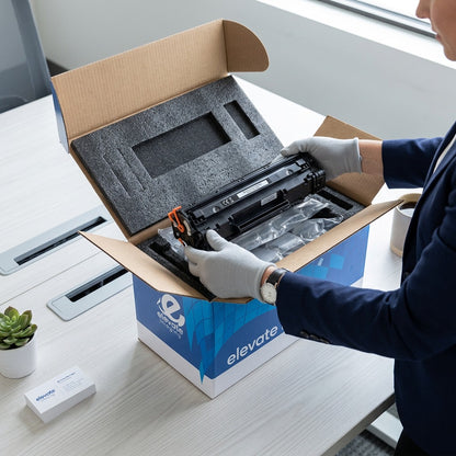 Unboxing an Elevate Imaging HP 12A compatible toner cartridge from protective foam packaging.