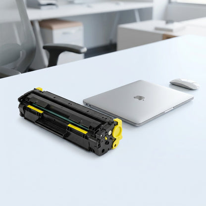 HP 644A Q5952A yellow printer toner cartridge on a white desk next to a laptop for scale reference.