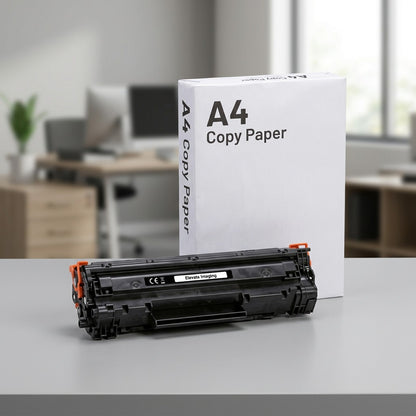 Elevate Imaging black toner cartridge shown beside a ream of A4 paper for scale on an office desk.