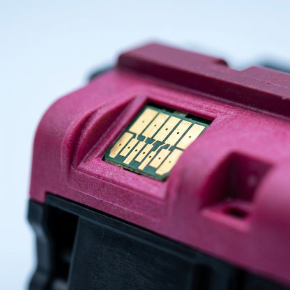 Macro view of gold electrical contact points on a magenta HP 645A C9733A remanufactured toner chip.