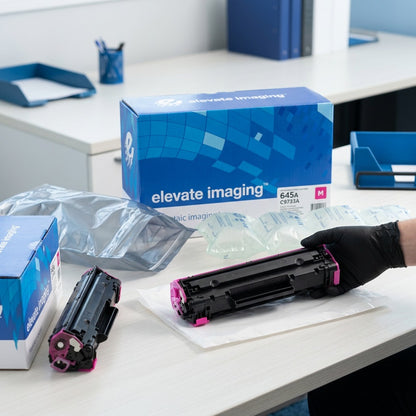 Unboxing of Elevate Imaging HP 645A C9733A magenta toner from secure protective shipping packaging.
