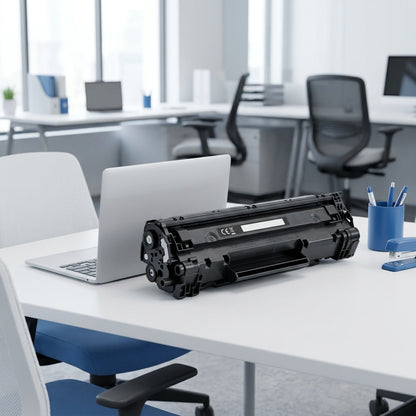 A black Elevate Imaging HP 647A toner cartridge on a desk next to a laptop for scale.