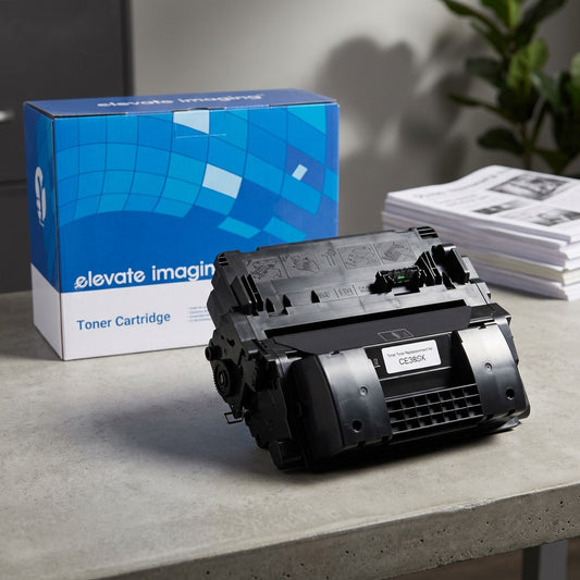 Elevate Imaging compatible HP 90X (CE390X) black toner cartridge on a desk with its blue box.