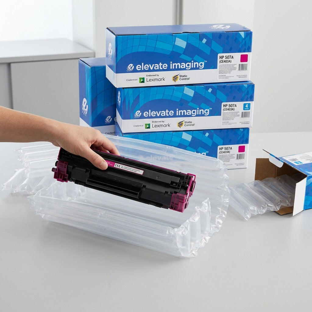A magenta HP 507A toner cartridge being unboxed from protective air-column packaging by Elevate Imaging.