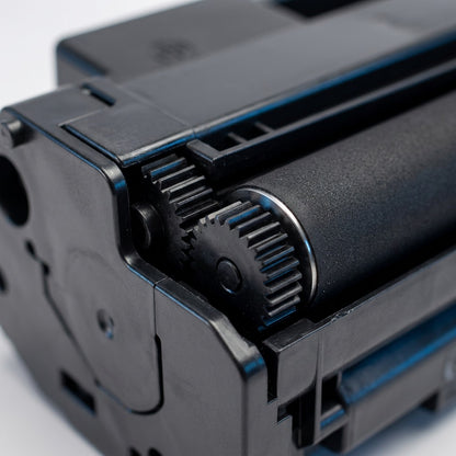 Macro detail of Elevate Imaging HP 05A toner cartridge gears and precision-engineered matte roller.