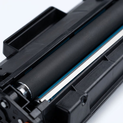 Macro detail of the developer roller and metal blade on a remanufactured HP 643A cyan toner.