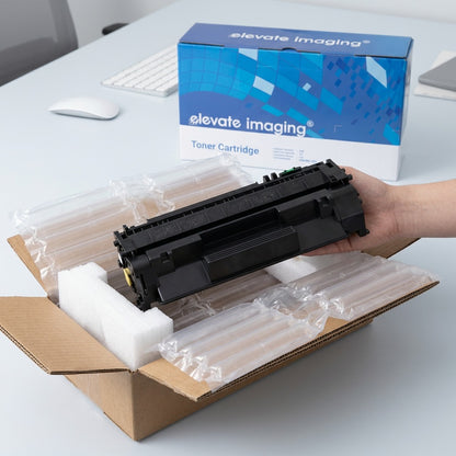 Unboxing an Elevate Imaging HP 80A CF280A black toner cartridge from protective air-cushioned packaging.