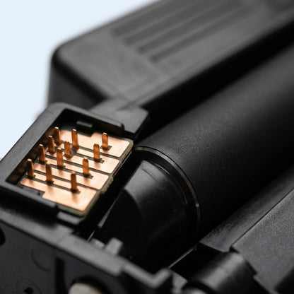 Macro detail of copper chip contacts and matte developer roller on an HP 87A CF287A toner cartridge.