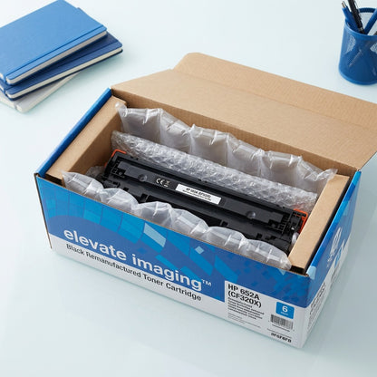 Elevate Imaging HP 652A (CF320X) black toner cartridge securely packed in an open retail box with protective air cushions.