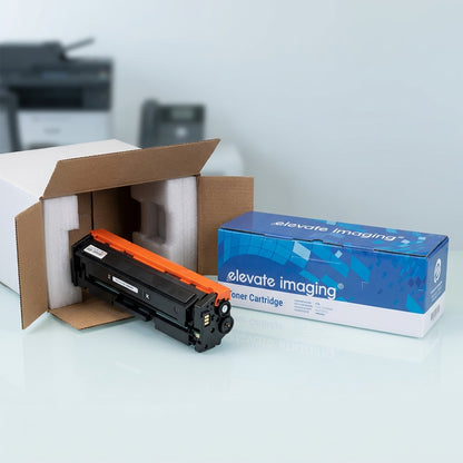 A compatible HP 201A black toner cartridge unboxed from protective foam packaging on a desk.