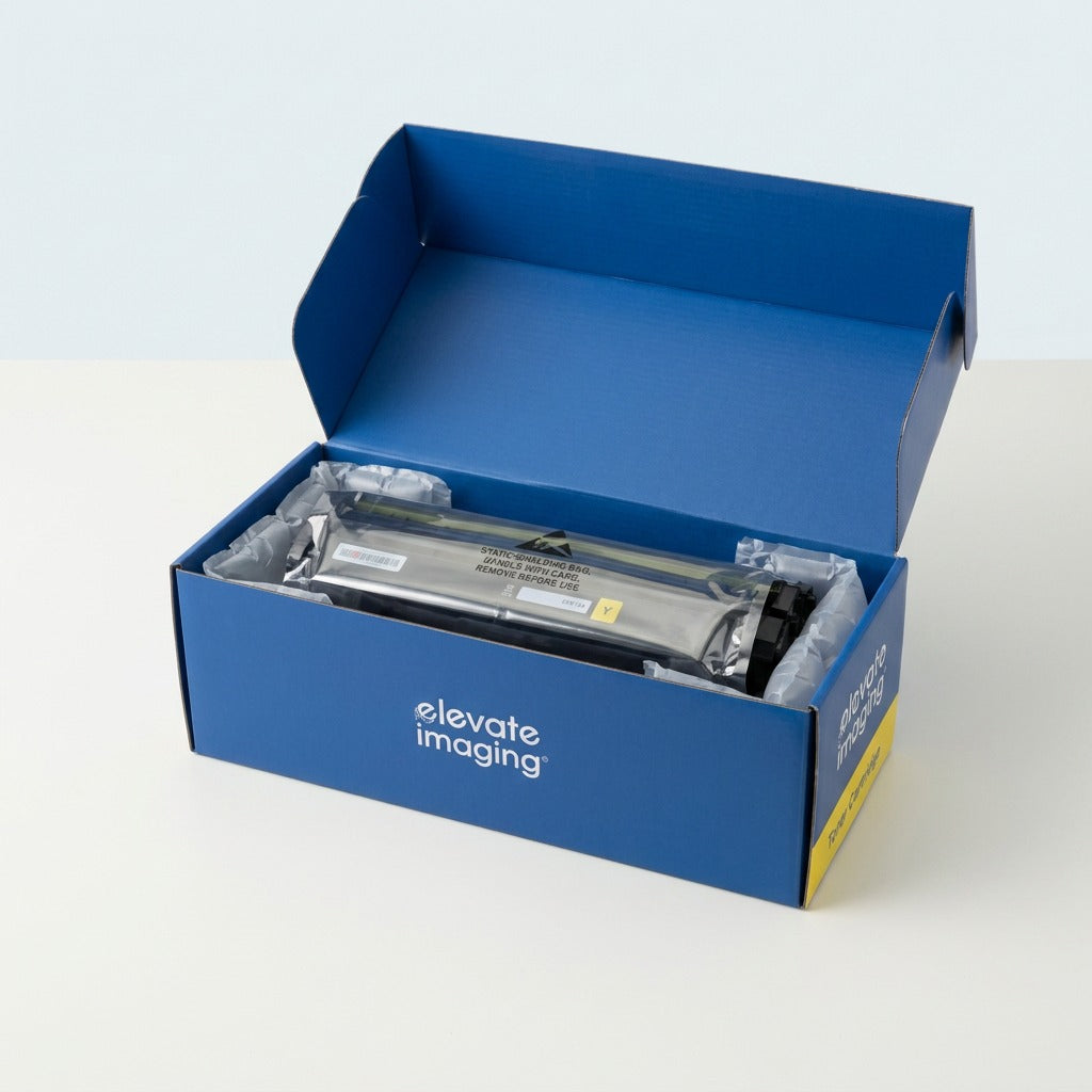 Open Elevate Imaging box showing a yellow HP 410X toner cartridge in protective air-cushion bags.