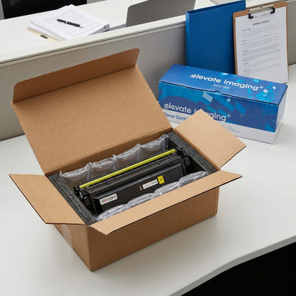 A remanufactured HP 410X yellow toner cartridge by Elevate Imaging, securely packaged in a shipping box with air cushions.