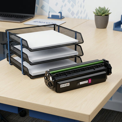 Elevate Imaging magenta HP 410X toner cartridge on a desk next to a paper tray for size reference.