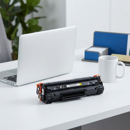 Elevate Imaging remanufactured HP 656X yellow toner cartridge on a desk beside a laptop and mug.