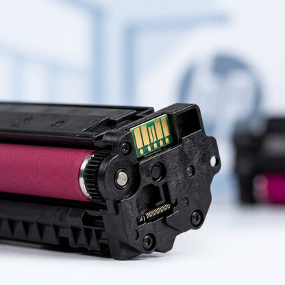 Macro view of the gold chip and magenta roller on an HP 73X CF473X remanufactured toner cartridge.