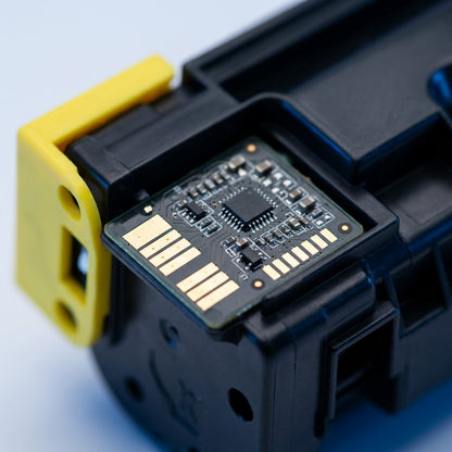 Macro close-up of the smart chip and gold contacts on a remanufactured HP 202X yellow toner cartridge.
