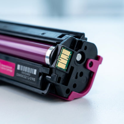 Macro view of gold electronic chip and developer roller on an Elevate Imaging HP CF503X magenta toner.